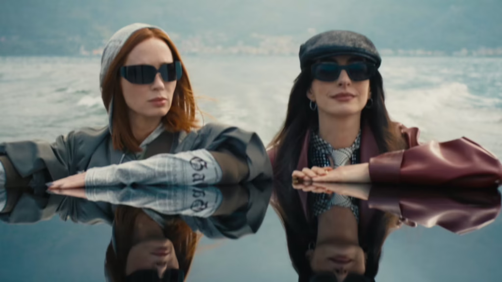 The Devil Wears Prada 2 still with two women wearing sunglasses beside water