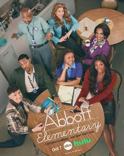 The cast of Abbott Elementary poses around a round table featuring the show’s logo, an October 2026 TV premiere date, and streaming service branding.