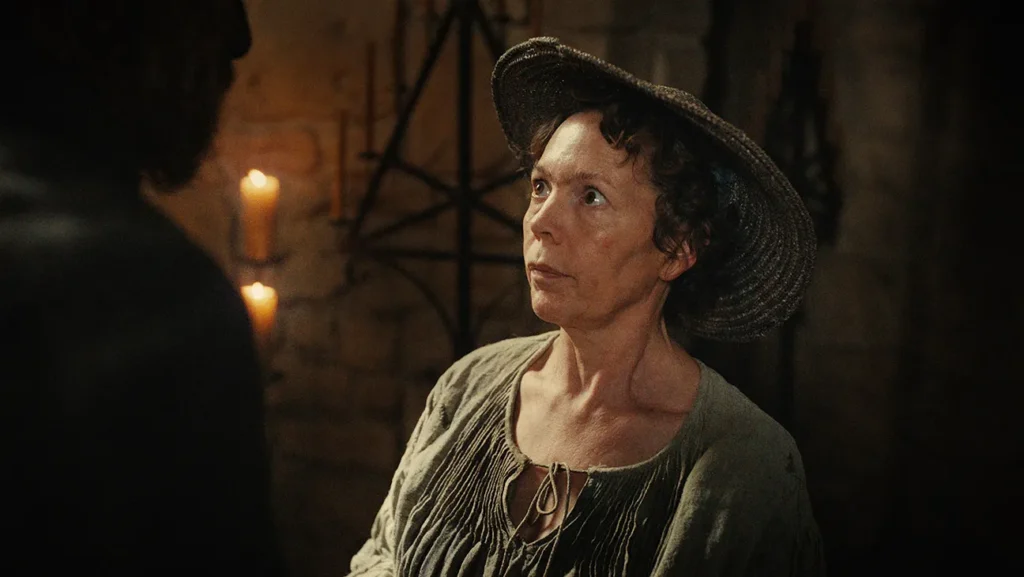 A woman in a straw hat and a simple top looks toward a person standing off-screen.