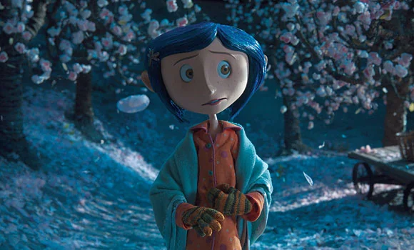 Coraline, a young girl with blue hair in a style reminiscent of Laika films, wears an orange patterned shirt, teal shawl, and striped gloves while standing in a garden with blooming trees.